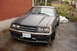 1981 Ford Mustang - This 1981 Ford Mustang is parked outside next to a brick wall and some overgrown bushes.