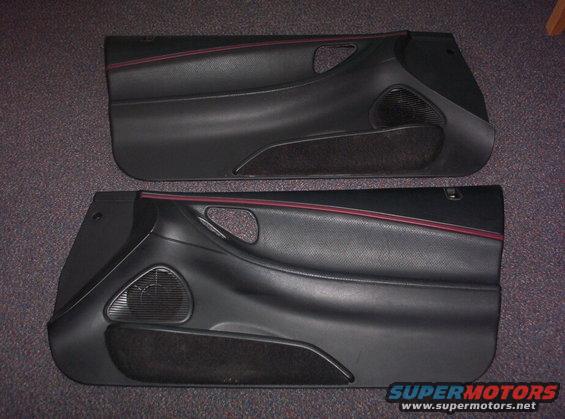 Two black car door panels with red trim and speaker grilles. Text at bottom says "SUPERMOTORS www.supermotors.net"