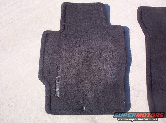 Two black car floor mats, one with embossed text that appears to say 'PROBE'
