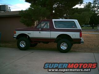 Maroon and white 1987-1991 Ford Bronco lifted with aftermarket wheels