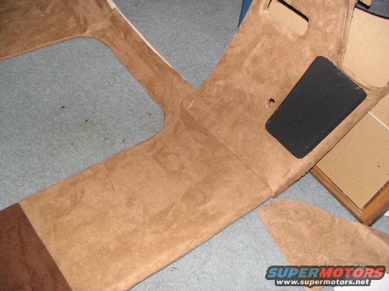 Tan suede-covered car interior trim panels with a black rectangular insert and cutouts