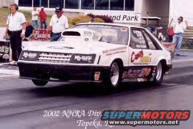 White drag car with 'Crazy Horse II' on the side, hood scoop, and racing decals
