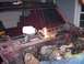1994 Ford Bronco - The interior of a red SUV shows significant damage to the windshield and exposed engine components, with a work light illuminating the dash…