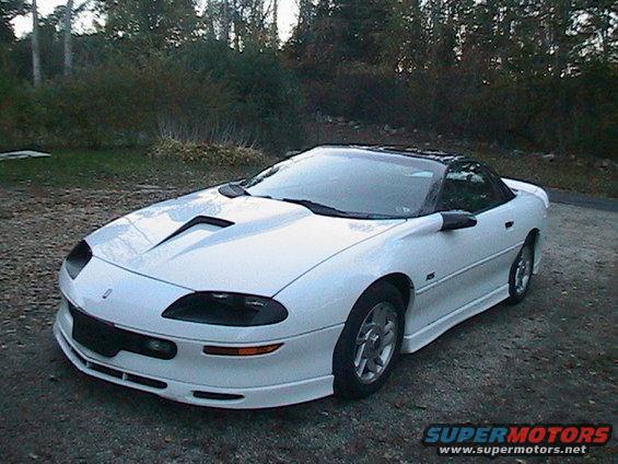 White 1996 Chevrolet Camaro parked outside with trees in the background