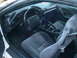 1996 Chevrolet Camaro - The interior of a 1996 Chevrolet Camaro features a dark dashboard, steering wheel, and cloth seats.