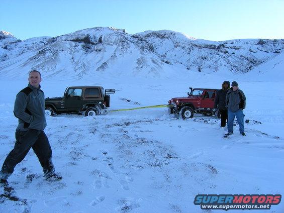 Two Jeeps stuck in snow, one towing the other