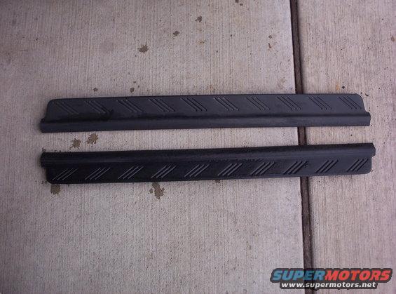 two black plastic door sill plates with diagonal tread pattern