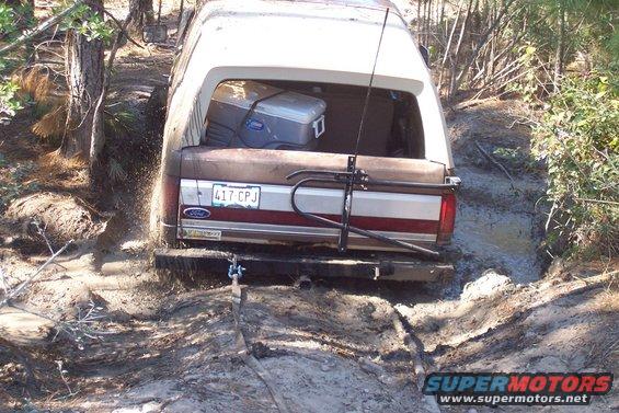Ford Bronco stuck in mud, rear view. License plate 417 CPJ visible