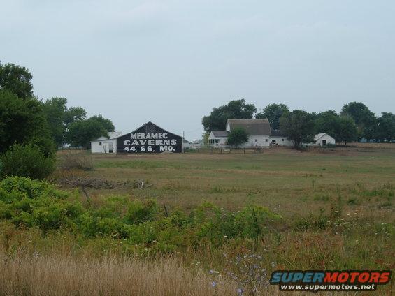 Farm buildings with "MERAMEC CAVERNS 44, 66, MO." painted on barn