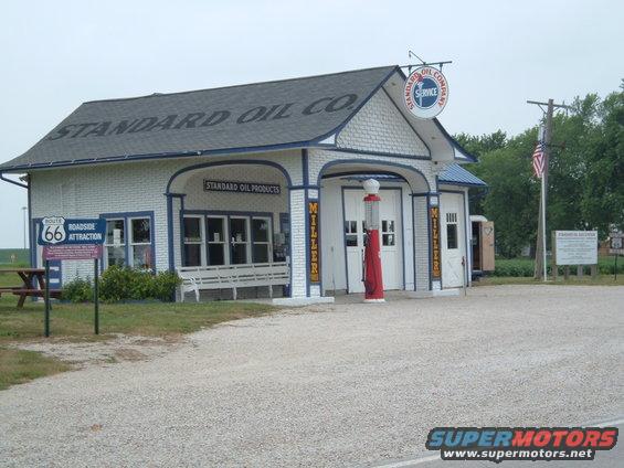 Standard Oil gas station with Route 66 roadside attraction sign and vintage gas pump