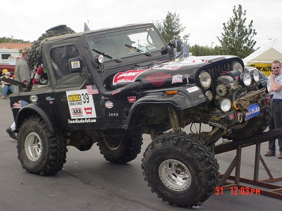 Modified 1976 Jeep CJ7 with large tires and off-road accessories. Number 39 on door
