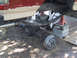 1990 Ford Bronco - Vehicle's rear axle removed for maintenance, showing suspension components and frame.