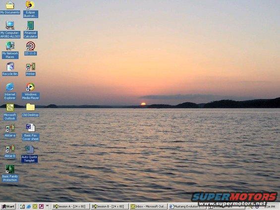 Desktop wallpaper showing a sunset over a body of water with a computer taskbar at the bottom