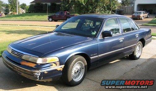 Blue 1994 Ford Crown Victoria, 3/4 front view, showing damage to front bumper