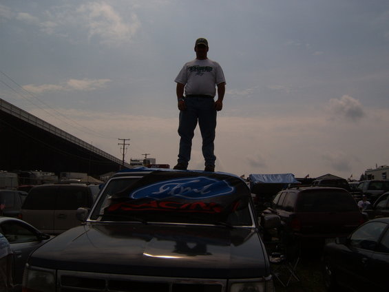 Dark SUV with Ford Racing banner on hood