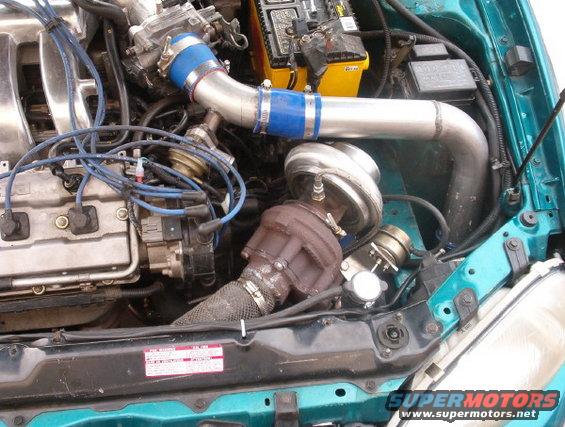 Engine bay with turbocharger and blue hoses
