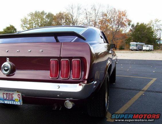 Rear of a 1969 Ford Mustang with a spoiler and triple taillights