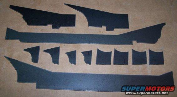 Collection of cut metal pieces laid out on a flat surface