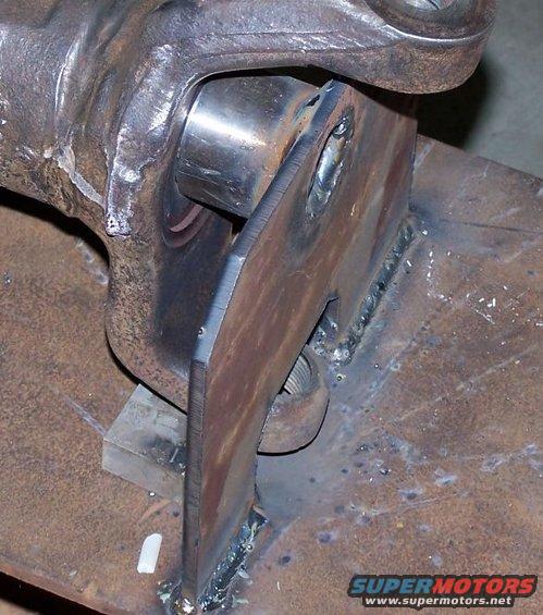 Welded metal bracket attached to a U-joint yoke