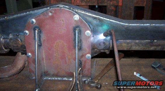 Welding a red differential cover onto a metal axle housing