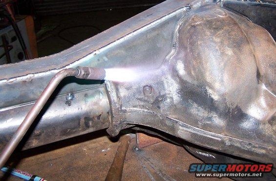 Close-up of a torch welding a metal frame component