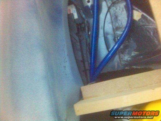 Blue metal bar and wooden blocks inside a car's interior