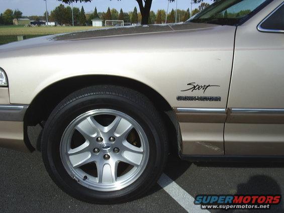 Tan 1993 Ford Crown Victoria Sport fender badge and alloy wheel