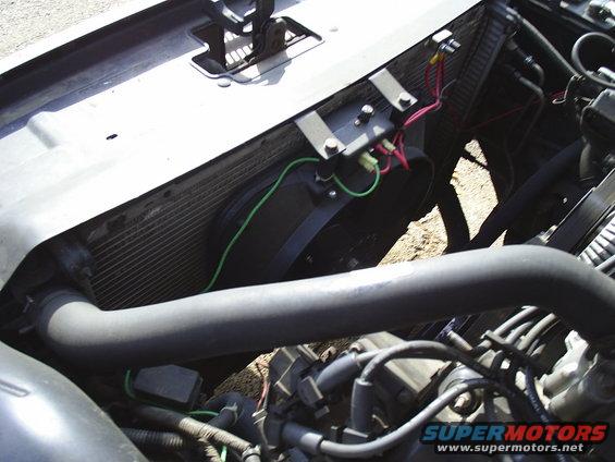 Engine bay showing radiator, fan, and hoses