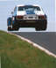 1981 Ford Mustang - This Ford Capri RS is captured mid-air during a race, its distinctive blue and white livery.