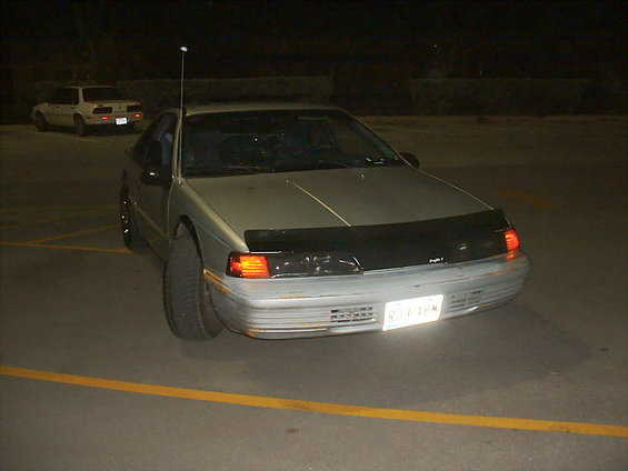 Silver 1992 Ford Thunderbird coupe, front view, with a black bug deflector and a visible license plate