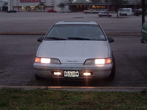 Silver 1992 Ford Thunderbird front view with headlights on