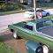 1970 Ford Ranchero - A green pickup truck with a white roof is parked in a driveway, with another vehicle visible in the background.
