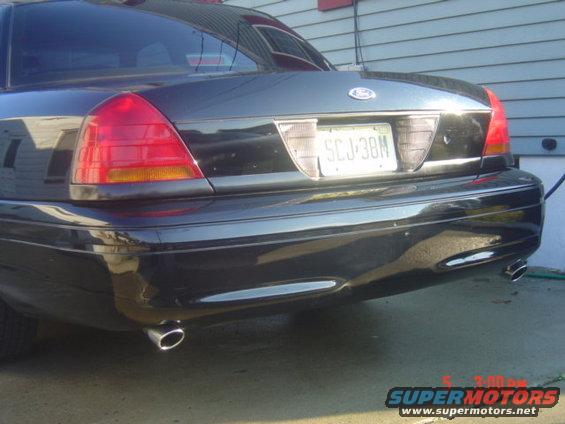 Rear of a black 1998 sedan with dual exhaust and a license plate reading SCJ-38M
