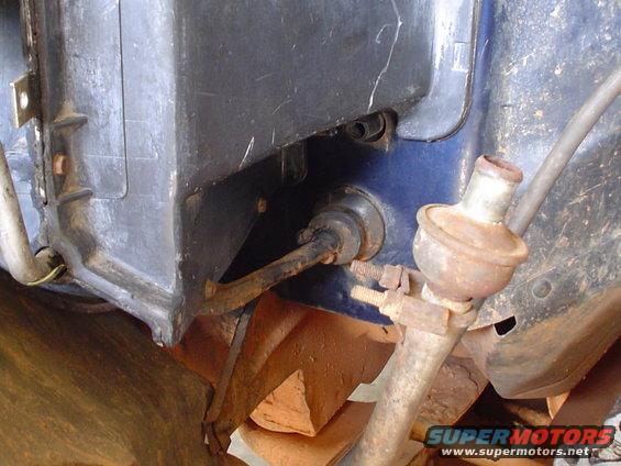 Close-up of a vehicle's interior HVAC component with rusted metal parts