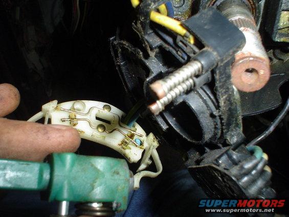 Close-up of a steering column electrical connector with wires and springs