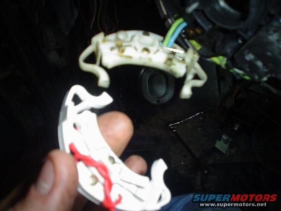 close-up of car interior wiring harness with white plastic connectors and red wire