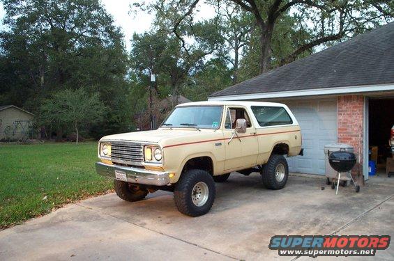 Tan 1978 Dodge Power Ram SUV with red pinstripes parked in driveway