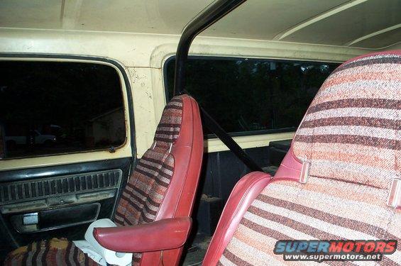 Interior view of striped seats and roll bar in a vehicle
