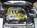 1996 Ford Probe - The engine bay features a Ford V6 engine with bright yellow spark plug wires and an aftermarket cold air intake system.