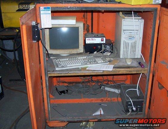 Orange cabinet with computer, keyboard, and monitor
