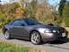 2004 Ford Mustang - A 2004 Ford Mustang convertible is shown from the front three-quarter view on a paved road.