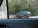 1992 Chevrolet S10 - SUV navigates a muddy trail with trees in the background.