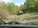 1992 Chevrolet S10 - Off-roading in a 1992 Chevrolet S10 on a wet, muddy trail surrounded by trees.