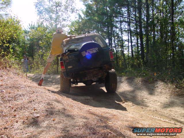 1992 Chevrolet S10 Blazer on dirt trail, man hanging off rear door