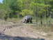 1992 Chevrolet S10 - Off-road vehicle stuck in mud on a wooded trail.