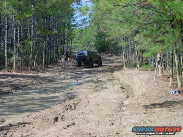 1992 Chevrolet S10, dark color, off-road, side view, muddy terrain