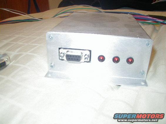Aluminum electronic box with DB9 connector and three red LEDs, wires visible