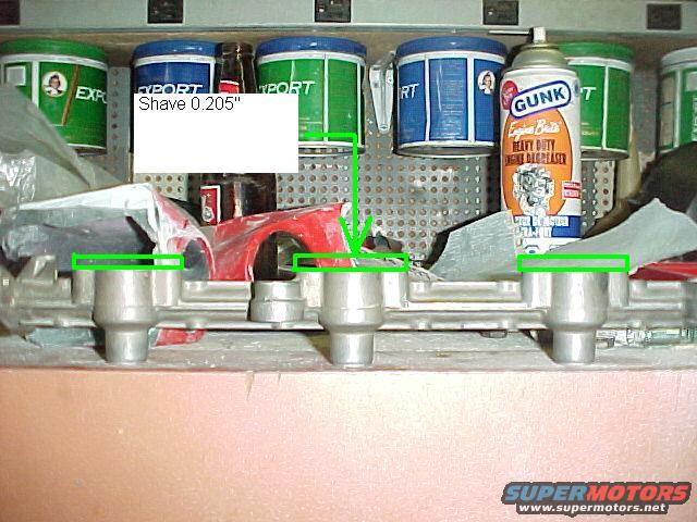 Engine intake manifold with "Shave 0.205"" label and GUNK engine degreaser can