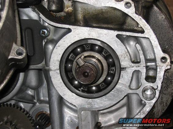 Close-up of a ball bearing inside an engine casing with visible gears