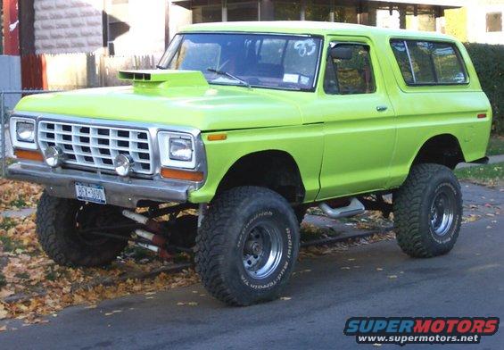 1978 Ford Bronco lifted with large tires and a hood scoop. License plate reads BEX-1600